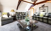 Roundhill Coach House - the inviting lounge with sumptuous seating and feature beams