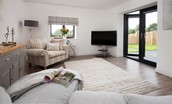 Sunwick Cottage - bright and comfortable sitting room with French doors leading out onto the patio