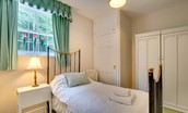 The Eslington Lodge - bedroom three with single bed and wardrobe