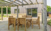 Bellshill Bothy - large patio with outdoor dining furniture under the pergola