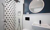 Seaside House - en-suite shower room containing walk-in shower with rainforest shower head and additional attachment, basin, mirror, heated towel rail and WC. (1)
