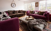Moo House - sitting room with large comfy sofas and armchairs where you can put your feet up after a busy day