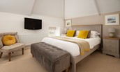 Samphire Barn - bedroom three with king size bed and wall-mounted TV