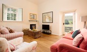 Laundry Cottage - sitting room with comfy sofas, TV and cosy log burner