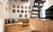 The Dovecot at Reedsford - cosy snug with bench seating, Smart TV, bespoke storage cabinet, and wood burner