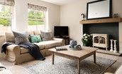 Partridge Lodge - calm and comfortable interiors in the sitting room with an electric fire available