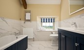 Shepherd's House - bedroom three en suite bathroom with bath, double basin, heated towel rail, WC.