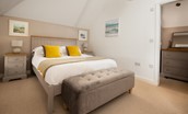 Samphire Barn - bedroom three with king size bed and ottoman
