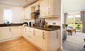 Bamburgh Five - well-equipped kitchen with sitting room beyond