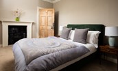 Cairnbank House - bedroom three with double bed and decorative fireplace