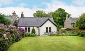Pentland Cottage - the pretty garden with lawn and colourful planting