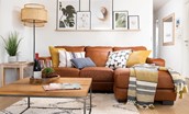 6 The Bay, Coldingham - the comfy tan leather chaise sofa is the perfect place to kick back after a day at the beach