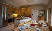 The Boathouse - the kitchen with dining table, large fridge freezer and two ovens
