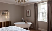 The Old Rectory - bedroom five on the first floor with freestanding roll-top bath
