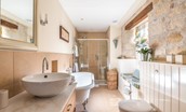 The Old Millhouse - The Esk bedroom en suite bathroom with roll top bath, WC, basin and walk-in shower