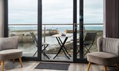 Wamsas Retreat - sliding glass door leading out onto the balcony with the harbour beyond