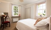 Redcliff - bedroom with double-aspect window and linen from The White Company