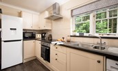 East Lodge at Ashiestiel - the galley style kitchen with views over to the forest