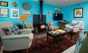 Brunton Granary - bright and colourful sitting room with cosy wood burner