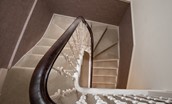 School View - graceful spiral staircase leading up the main living area
