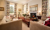 East House - drawing room with ample seating and wood burning stove