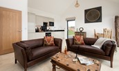 The Elm - open plan living room with two-seater leather sofas