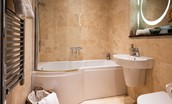 Skyfall - family bathroom with P-shaped bath with shower above, heated towel rail, WC and basin