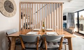 Red Herring - dining table with 4 chairs and bench seating in the open-plan living area