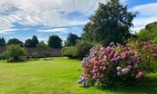 The White House - spacious lawned garden with colourful Rhododendrons