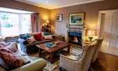 The Boathouse - the drawing room with bay window and views of the River Tweed