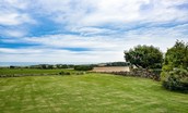 Calder Cottage - large lawned garden looking towards the sea, Embleton Bay and Dunstanburgh Castle
