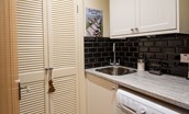 Skyfall - ground floor utility room with washer/dryer combi and storage space