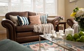 Friars Farm Cottage - comfortable leather sofas in the sitting room