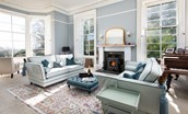 Cairnbank House - the drawing room with sumptuous sofas set around the wood burning stove