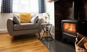 Peewit Cottage - a log burner turns the sitting room into a cosy and homely space