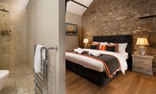 Coach House - bedroom one with zip and link beds and en suite bathroom with large walk-in shower