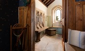 Lindisfarne View - the characterful boot room with stone floor, vaulted ceiling and original arched window