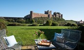 Bamburgh Five - enjoy al fresco dining on the patio with the communal gardens and views of Bamburgh castle beyond