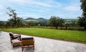 The Sheep Fold - large patio to the rear of the property with lawned garden beyond
