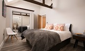 The Steading at West Lyham - bedroom four with king size bed, side tables and double wardrobe