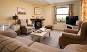 Bee Cottage - a comfortable sitting room with seating for four and a cosy log burner
