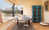 Lakeside Cottage - Emily - a window seat sits beneath the corner window in the dining area