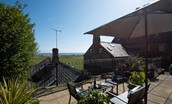 Marine House Cottage - raised terrace with garden furniture and far reaching views out to sea