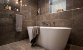Roundhill Coach House - freestanding bath and quality toiletries in the master bathroom