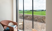 Lookout South - large feature window with seating and views over rolling farmland