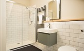 Trouthouse - large walk-in shower in the main bathroom with heated towel rail and wall-hung basin