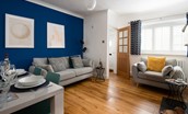 Peewit Cottage - bright and airy sitting and dining room with eye-catching feature wall