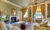 Eslington East Wing - drawing room with open fire and door out to the grounds