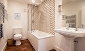 Brunton Lake - family bathroom containing deep bath with rainforest shower over