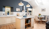 Hiddenhus - the newly-fitted kitchen is filled with light from the velux windows above the dining area